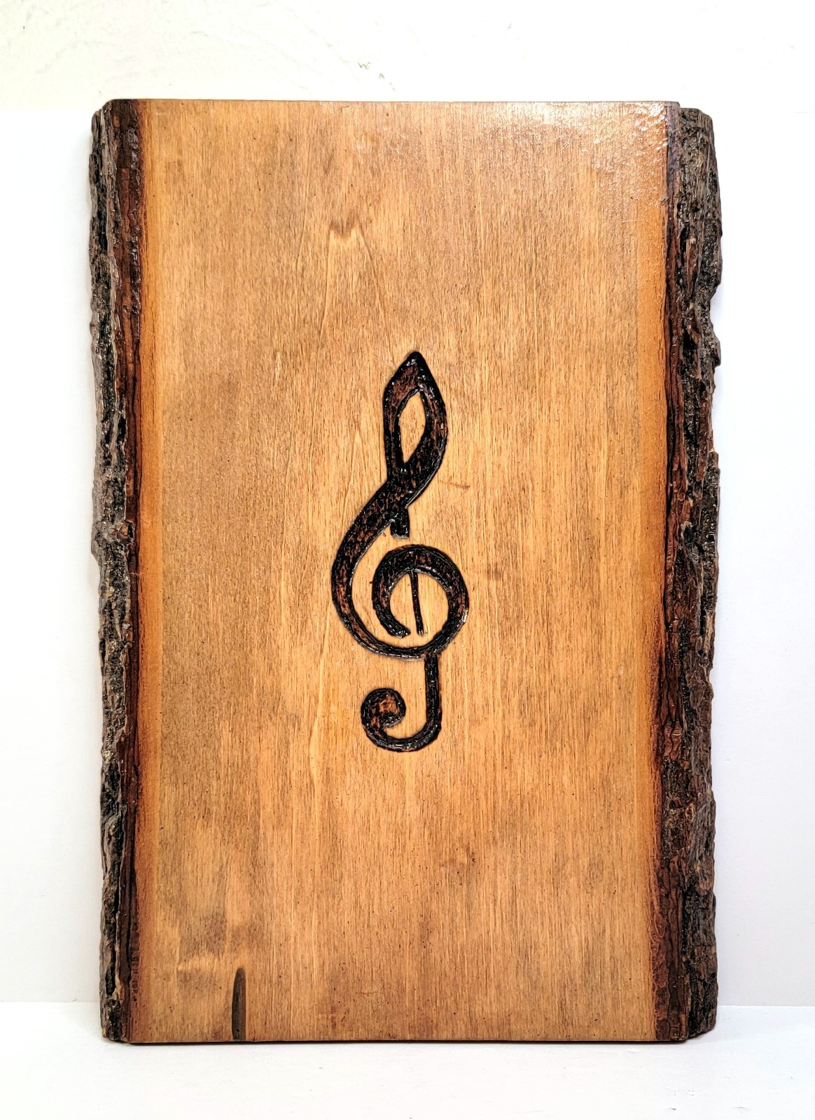 Handmade Wood slice wall art with engraved Treble or G Clef music note.