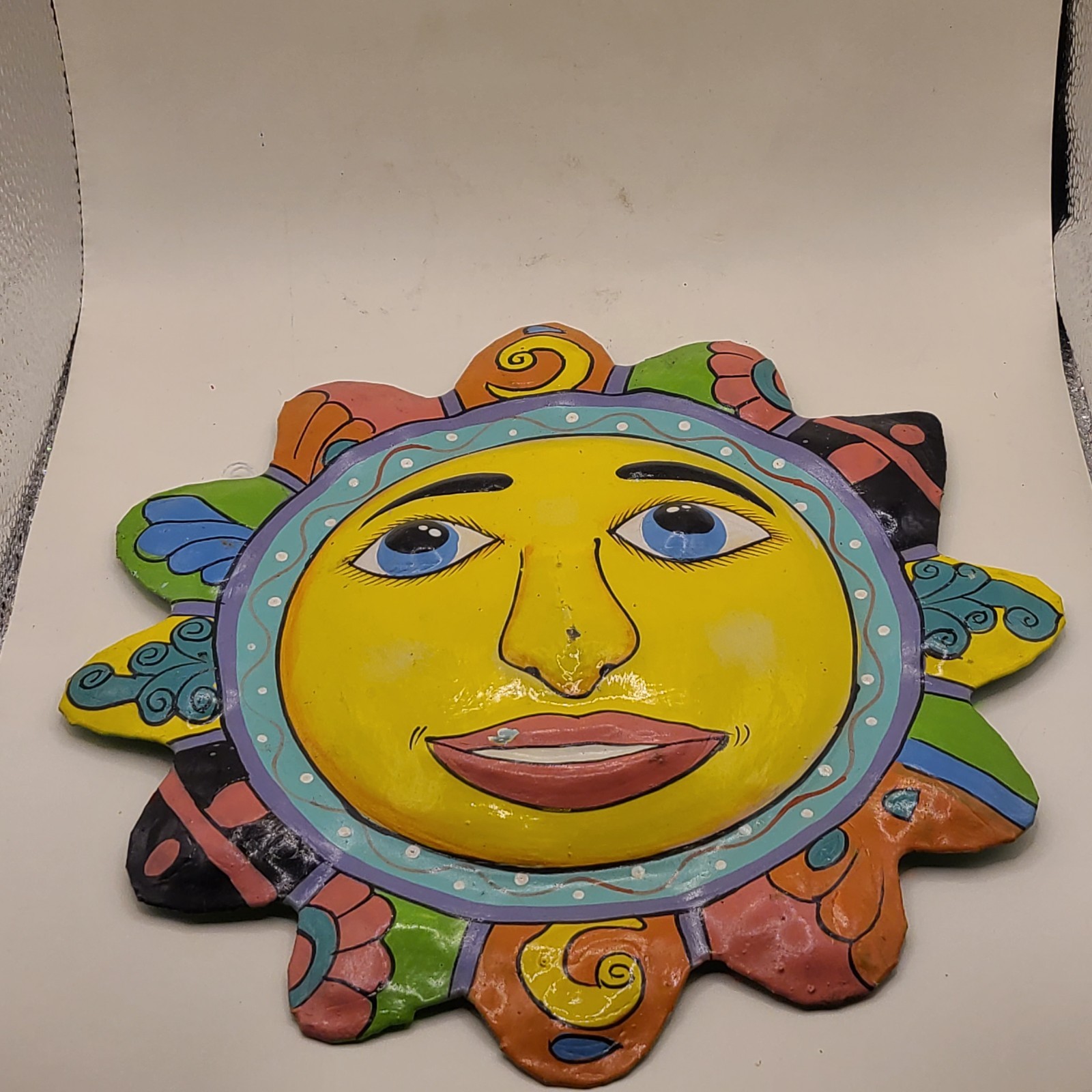 Celestial sun in metal wall hanging. Multicolor. Haiti. Garden art. Paint chips.