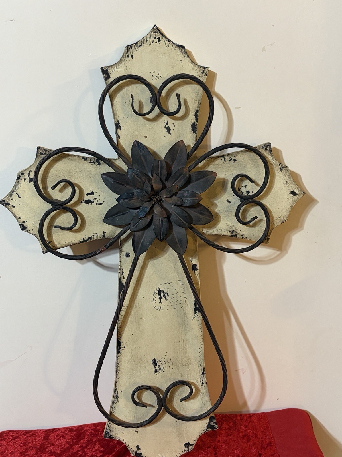 Rustic-style decorative wall cross with a wooden base and metal details.