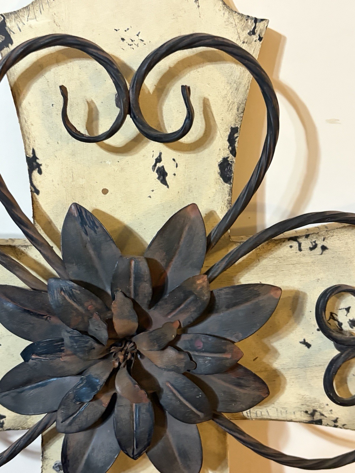 Rustic-style decorative wall cross with a wooden base and metal details.