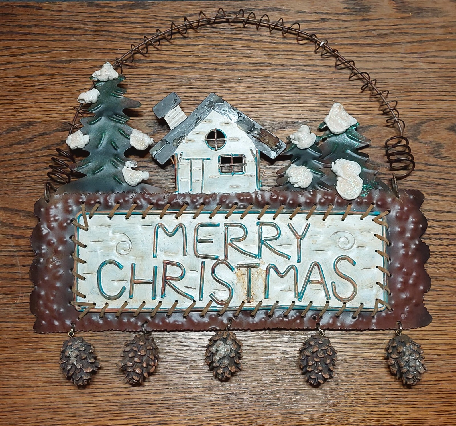 Winter rustic cabin forest scene “Merry Xmas” wall hanging w/dangling pine cones