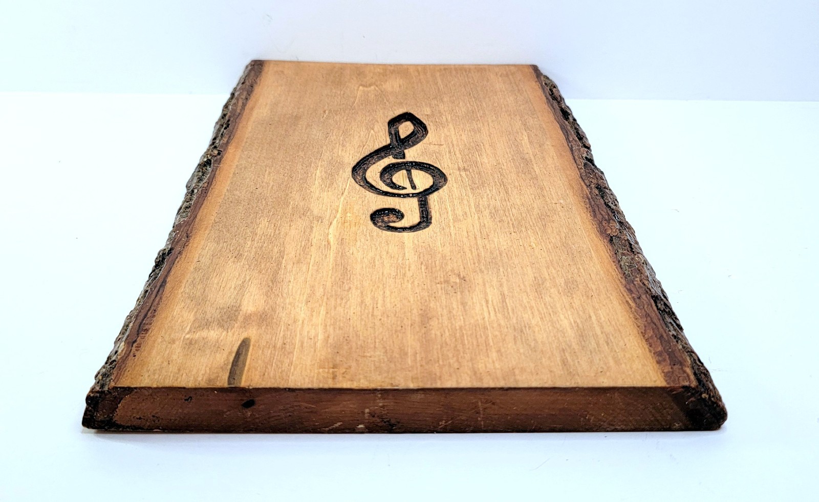Handmade Wood slice wall art with engraved Treble or G Clef music note.