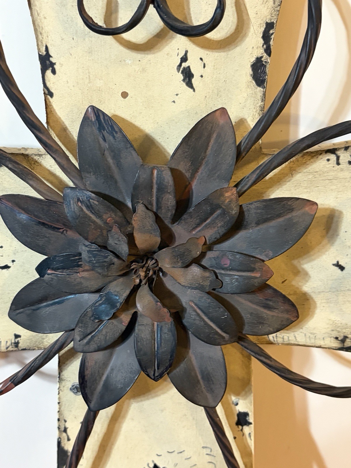 Rustic-style decorative wall cross with a wooden base and metal details.